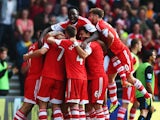 Rickie Lambert of Southampton is surrounded by team mates after scoring during the Barclays Premier League match between Southampton and Crystal Palace at St Mary's Stadium on September 28, 2013