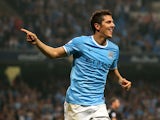 Man City's Stevan Jovetic celebrates after scoring his team's fourth goal against Wigan during their League Cup match on September 24, 2013