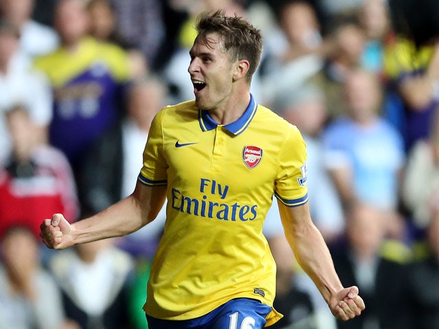 Aaron Ramsey celebrates after scoring their second goal during the Barclays Premier League match between Swansea City and Arsenal at Liberty Stadium on September 28, 2013