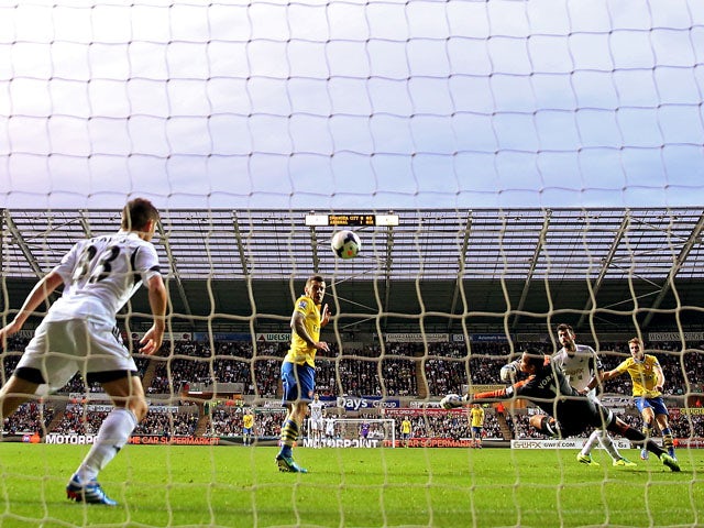 Aaron Ramsey of Arsenal scores their second goal during the Barclays Premier League match between Swansea City and Arsenal at Liberty Stadium on September 28, 2013