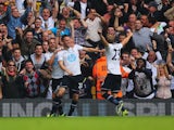 Gylfi Sigurdsson of Tottenham Hotspur (22) celebrates in front of fans with Roberto Soldado (L) and Christian Eriksen (R) during the Barclays Premier League match between Tottenham Hotspur and Chelsea at White Hart Lane on September 28, 2013
