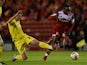 Middlesbrough's Albert Adomah and Huddersfield's Anthony Gerrard battle for the ball during their Championship match on October 1, 2013