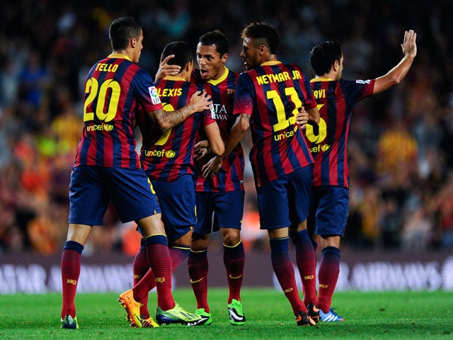 Alexis Sanchez of FC Barcelona celebrates with his team-mates after scoring his team's first goal during the La Liga match between FC Barcelona and Real Valladolid CF at Camp Nou on October 5, 2013