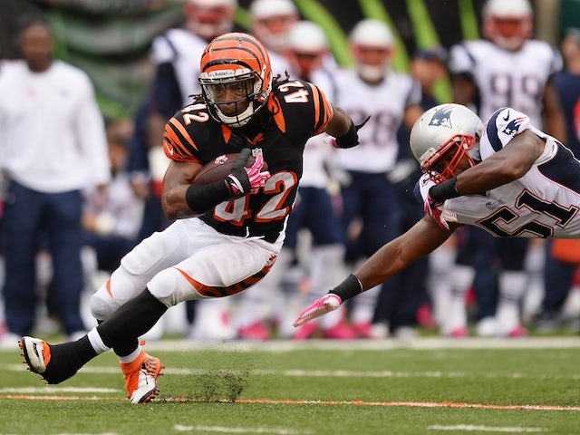 BenJarvus Green-Ellis of the Cincinnati Bengals breaks a tackle attempt from Jerod Mayo of the New England Patriots during the match on October 6, 2013