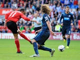 Peter Odemwingie of Cardiff City scores a goal past Fabricio Coloccini of Newcastle United during the Barclays Premier League match between Cardiff City and Newcastle United at Cardiff City Stadium on October 5, 2013 