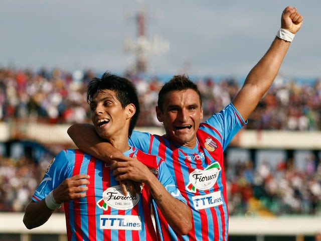 Pablo Barrientos of Catania celebrates after scoring the opening goal with his teammate Gonzalo Bergessio during the Serie A match between Calcio Catania and Genoa CFC at Stadio Angelo Massimino on October 6, 2013