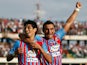 Pablo Barrientos of Catania celebrates after scoring the opening goal with his teammate Gonzalo Bergessio during the Serie A match between Calcio Catania and Genoa CFC at Stadio Angelo Massimino on October 6, 2013