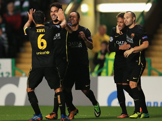 Barcelona's Cesc Fabregas celebrates with teammates after scoring the opening goal against Celtic during their Champions League group match on October 1, 2013