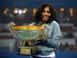 Serena Williams of the United States poses with her trophy during the medal ceremony after winning against Jelena Jankovic of Serbia on day night of the Women's Single Final of the China Open at the China National Tennis Center on October 6, 2013