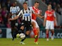 Dan Gosling of Newcasle battles Stewart Drummond of Morecambe during the Capital One Cup Second Round match between Morecambe and Newcastle United at the Globe Arena on August 28, 2013