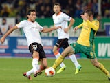 Valencia's Daniel Parejo and Kuban's Artur Tlisov battle for the ball during their Europa League group match on October 3, 2013