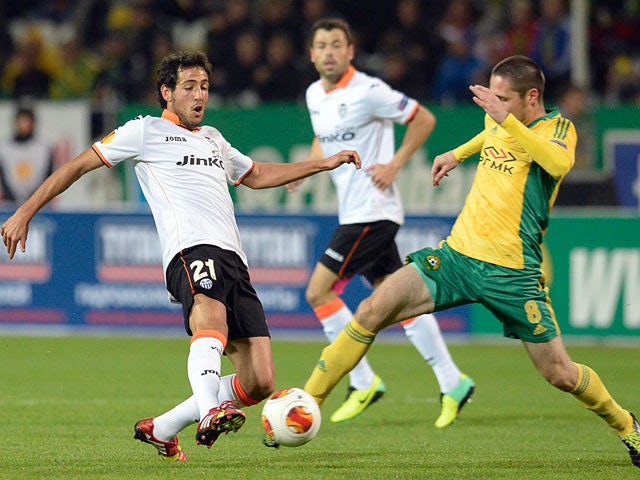 Valencia's Daniel Parejo and Kuban's Artur Tlisov battle for the ball during their Europa League group match on October 3, 2013