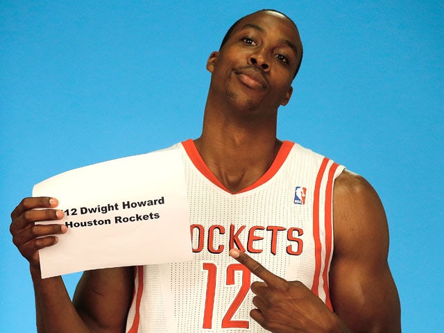 Dwight Howard #12 of the Houston Rockets poses for a team photographer during Houston Rockets Media Day at the Toyota Center on September 27, 2013