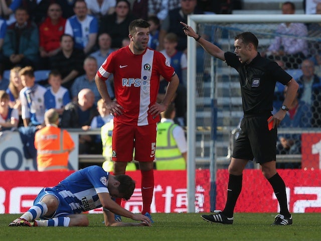 Grant Hanley of Blackburn Rovers is sent off by referee Mr Stuart Attwell during the Sky Bet Championship game against Wigan on October 6, 2013