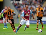 Gabriel Agbonlahor of Aston Villa is pursued by Curtis Davies of Hull during the Barclays Premier League match between Hull City and Aston Villa at KC Stadium on October 5, 2013