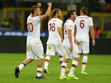 Francesco Totti of AS Roma celebrates scoring the first goal during the Serie A match between FC Internazionale Milano and AS Roma at Stadio Giuseppe Meazza on October 5, 2013