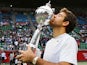 Winner Juan Martin Del Potro of Argentina kisses his trophy at trophy ceremony after winning his men's singles final match against Milos Raonic of Canada on day seven of the Rakuten Open at Ariake Colosseum on October 6, 2013