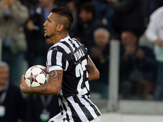 Arturo Vidal of Juventus celebrates after scoring his team's first goal from a penalty to equalise during the UEFA Champions League Group B match between Juventus and Galatasaray AS at Juventus Arena on October 2, 2013