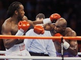 WBA and IBF Heavyweight Champion Evander Holyfield and WBC Heavyweight Champion Lennox Lewis exchange punches in the first round of their Vegas bout on November 14, 1999