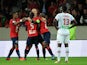 Lille's Senegalese midfielder Idrissa Gueye celebrates with teammates after scoring during a french L1 football match Lille vs Ajaccio on October 05, 2013
