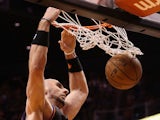 Marcin Gortat #4 of the Phoenix Suns slam dunks the ball against the Boston Celtics during the NBA game at US Airways Center on February 22, 2013