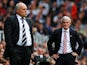 Fulham manager Mark Hughes looks on as Stoke boss Martin Jol watches the Barclays Premier League game between their sides on October 5, 2013