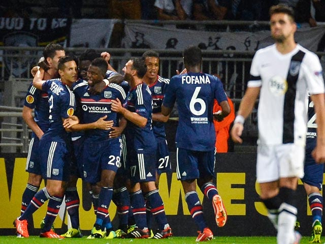 Lyon's Maxime Gonalons is congratulated by teammates after scoring the equaliser against Vitoria de Guimaraes during their Europa League group match on October 3, 2013