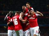 Arsenal's Mesut Ozil is congratulated by teammates after scoring the opening goal against Napoli during their Champions League group match on October 1, 2013