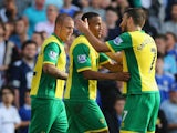 Robert Snodgrass of Norwich City celebrates with Martin Olsson of Norwich City after Anthony Pilkington of Norwich City scores their first goal during the Barclays Premier League match between Norwich City and Chelsea at Carrow Road on October 6, 2013