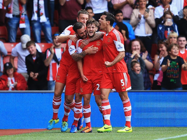 Adam Lallana of Southampton celebrates with team mates as he scores their first goal during the Barclays Premier League match between Southampton and Swansea City at St Mary's Stadium on October 6, 2013