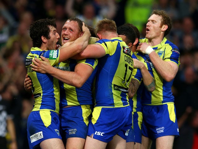 Ben Westwood of Warrington celebrates with teammates after scoring his team's third try during the Super League Grand Final between Warrington Wolves and Wigan Warriors at Old Trafford on October 5, 2013