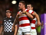 Michael McIlorum of Wigan is hugged by teammate Ben Flower after scoring his team's second try during the Super League Grand Final between Warrington Wolves and Wigan Warriors at Old Trafford on October 5, 2013