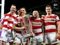 Pat Richards, Sam Tomkins, Michael McIlorum and Sean O'Loughlin of Wigan celebrate with the trophy following their team's 30-16 victory during the Super League Grand Final between Warrington Wolves and Wigan Warriors at Old Trafford on October 5, 2013