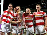 Pat Richards, Sam Tomkins, Michael McIlorum and Sean O'Loughlin of Wigan celebrate with the trophy following their team's 30-16 victory during the Super League Grand Final between Warrington Wolves and Wigan Warriors at Old Trafford on October 5, 2013