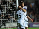 Swansea's Wayne Routledge is congratulated by teammate Michu after scoring the opening goal against St Gallen during their Europa League group match on October 3, 2013