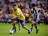 Mesut Oezil of Arsenal is chased by Claudio Yacob of West Bromwich Albion during the Barclays Premier League match between West Bromwich Albion and Arsenal at The Hawthorns on October 6, 2013