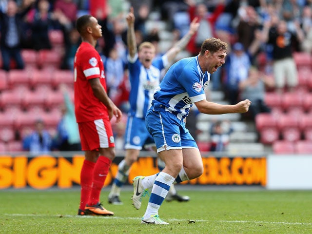 Grant Holt of Wigan Athletic celebrates after scoring his teams first goal and equaliser during the Sky Bet Championship match between Wigan Athletic and Blackburn Rovers at DW Stadium on October 6, 2013