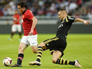 Manchester's striker Angelo Henriquez and AIK's defender Alexander Milosevic vie for the ball during the friendly football match AIK vs Manchester United on August 6, 2013 