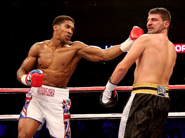 Anthony Joshua catches Emanuele Leo during their Heavyweight bout at O2 Arena on October 5, 2013