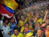 Colombian fans celebrate in Bogota after their team qualified for the Brazil 2014 FIFA World Cup on October 11, 2013