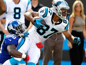 Domenik Hixon of the Carolina Panthers stretches for extra yardage after making a first down catch against Prince Amukamara of the New York Giants on September 22, 2013