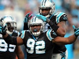 Dwan Edwards of the Carolina Panthers celebrates after a sack with teammate Frank Alexander during their game against the Oakland Raiders on December 23, 2012