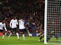 Wayne Rooney of England scores the first goal past Vukasin Poleksic of Montenegro during the FIFA 2014 World Cup Qualifying Group H match between England and Montenegro at Wembley Stadium on October 11, 2013