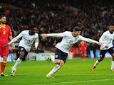 Wayne Rooney of England celebrates scoring the first goal with Danny Welbeck of England during the FIFA 2014 World Cup Qualifying Group H match between England and Montenegro at Wembley Stadium on October 11, 2013