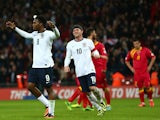 Daniel Sturridge of England celebrates with Wayne Rooney of England after scoring from penalty spot during the FIFA 2014 World Cup Qualifying Group H match between England and Montenegro at Wembley Stadium on October 11, 2013