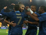 Karim Benzema of France is mobbed by team mates after scoring the sixth goal during the International Friendly match between France and Australia at Parc des Princes on October 11, 2013