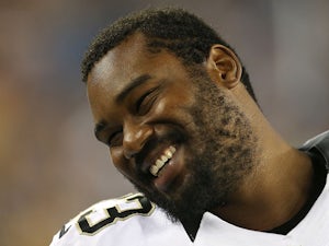 Jahri Evans #73 of the New Orleans Saints reacts on the sideline during a preseason game against the New England Patriots in the first half at Gillette Stadium on August 9, 2012