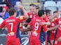 Jeronimo Neumann of Adelaide United celebrates a goal with teamates during the round one A-League match against Perth Glory on October 13, 2013