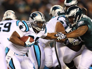 Jonathan Stewart #28 of the Carolina Panthers carries the ball as Cullen Jenkins #97 of the Philadelphia Eagles defends on November 26, 2012