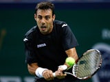 Marcel Granollers of Spain returns a shot to Janko Tipsarevic of Serbia during day one of the Shanghai Rolex Masters at the Qi Zhong Tennis Center on October 7, 2013